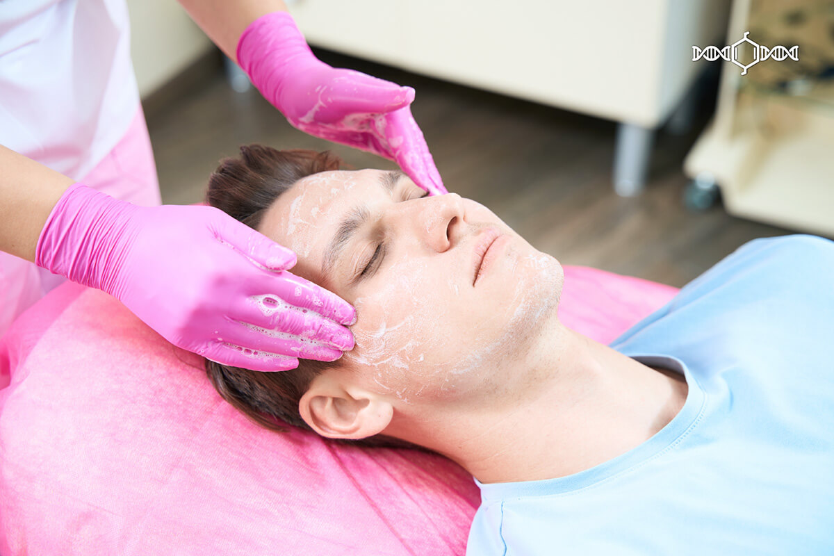 Caucasian man getting a facial treatment in a spa