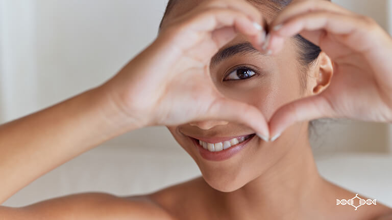 Woman holding heart-shaped hands
