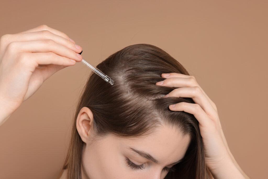 Woman using a scalp serum