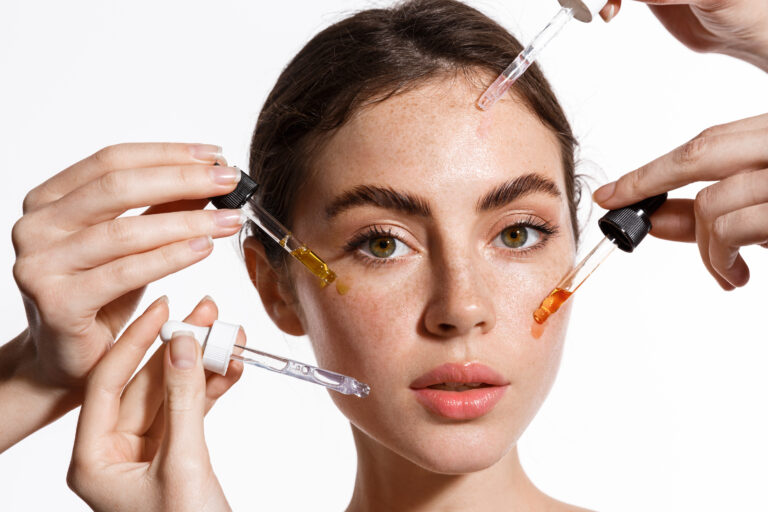 Woman using different serums for skincare
