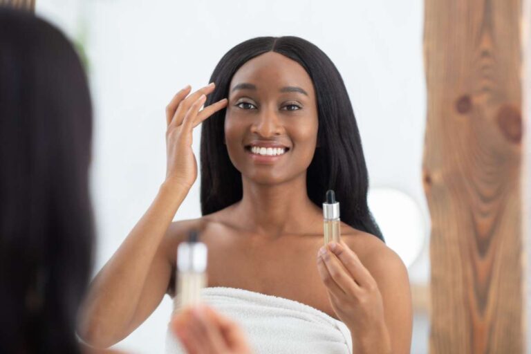 Woman applying facial serum as part of a peptide therapy skincare routine to support skin renewal and radiance