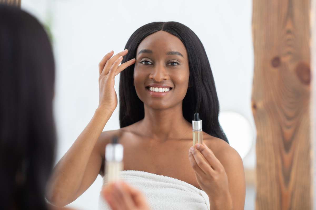 Woman applying facial serum as part of a peptide therapy skincare routine to support skin renewal and radiance