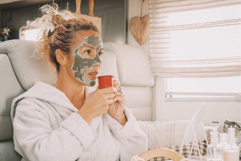 Woman applying travel skincare clay mask to support skin barrier while exposed to dry cabin-like conditions and environmental stressors.