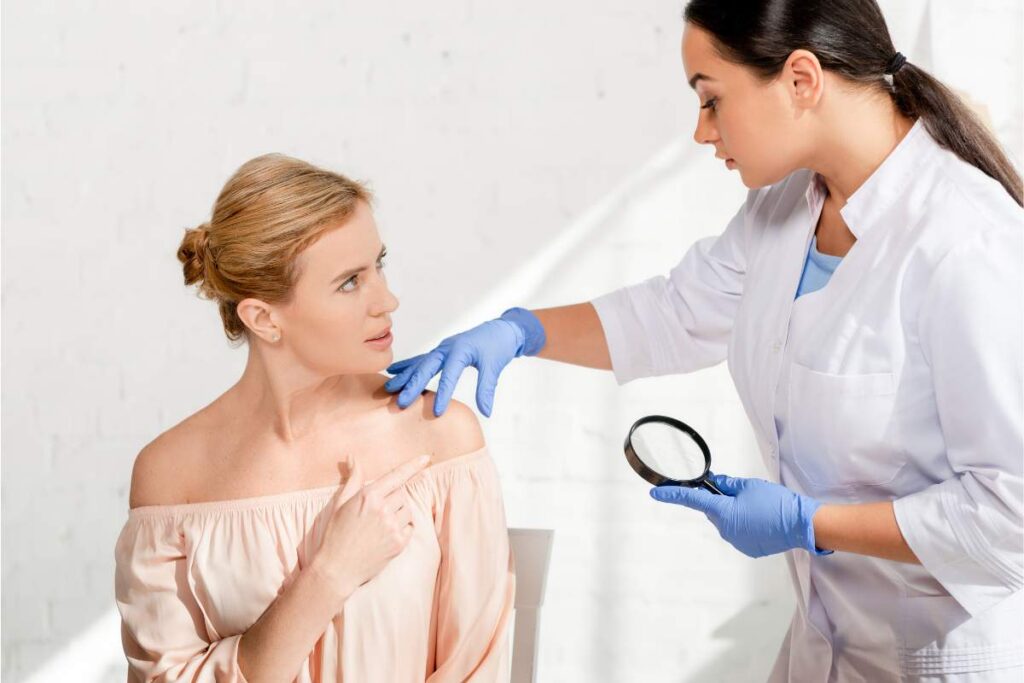 Dermatologist examining a patient's skin during a clinical consultation to support personalised peptide therapy and advanced skincare.
