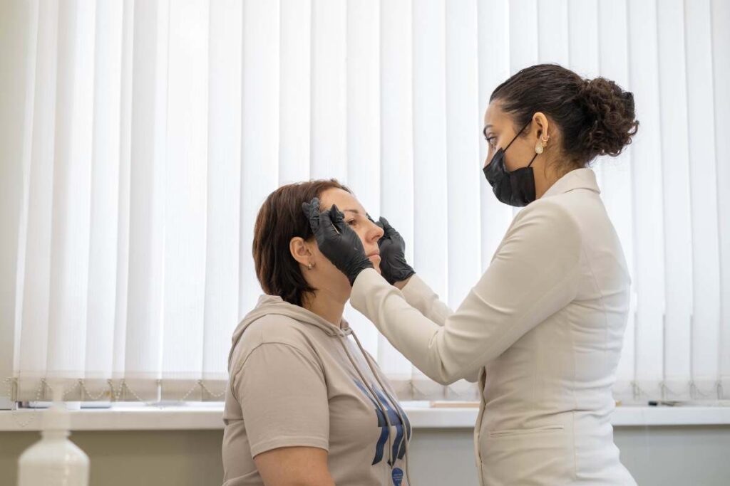 Dermatologist assessing a patient's skin during a consultation to recommend personalised pigmentation products.